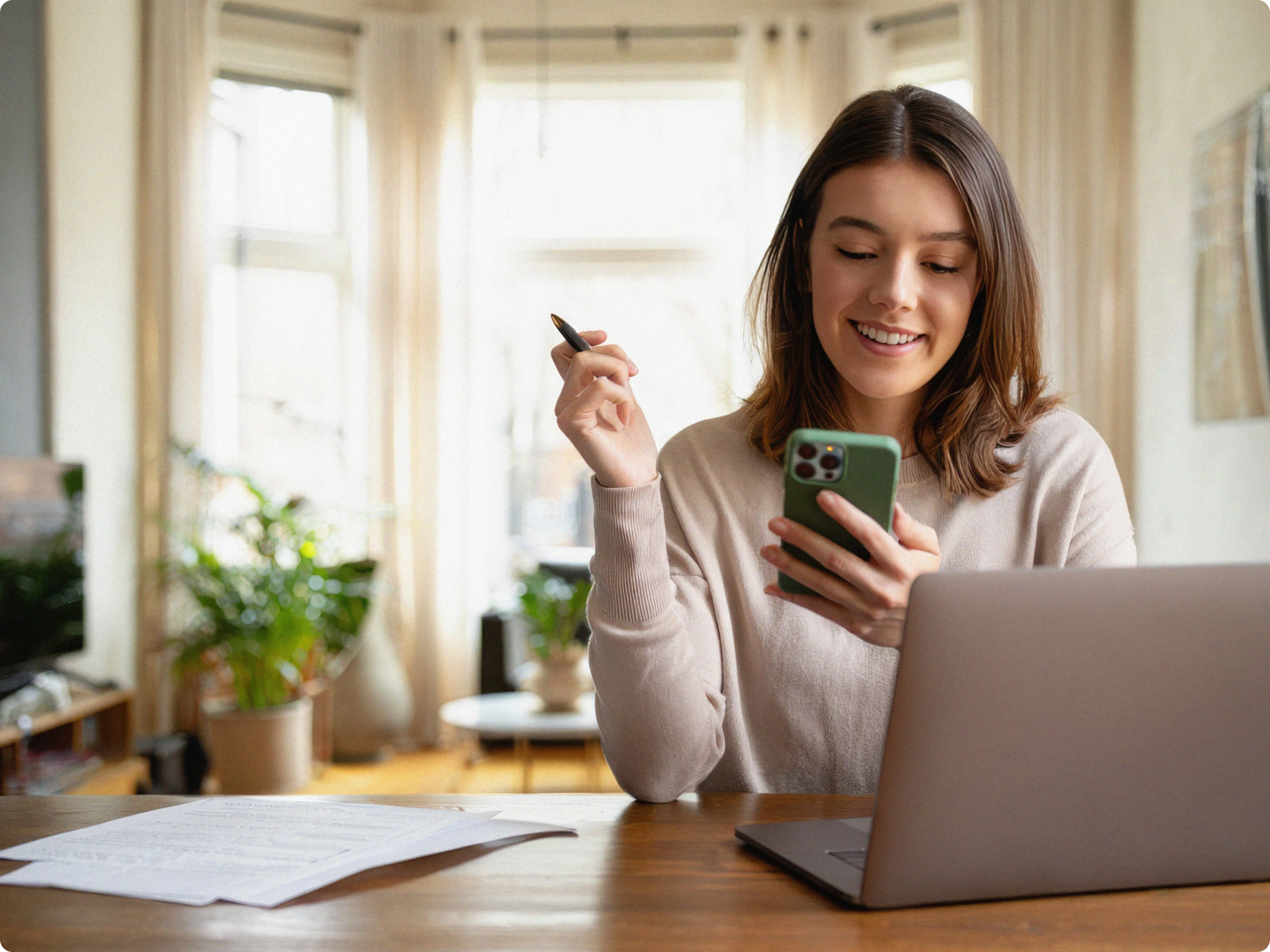 A person filing their taxes and looking at their phone.
