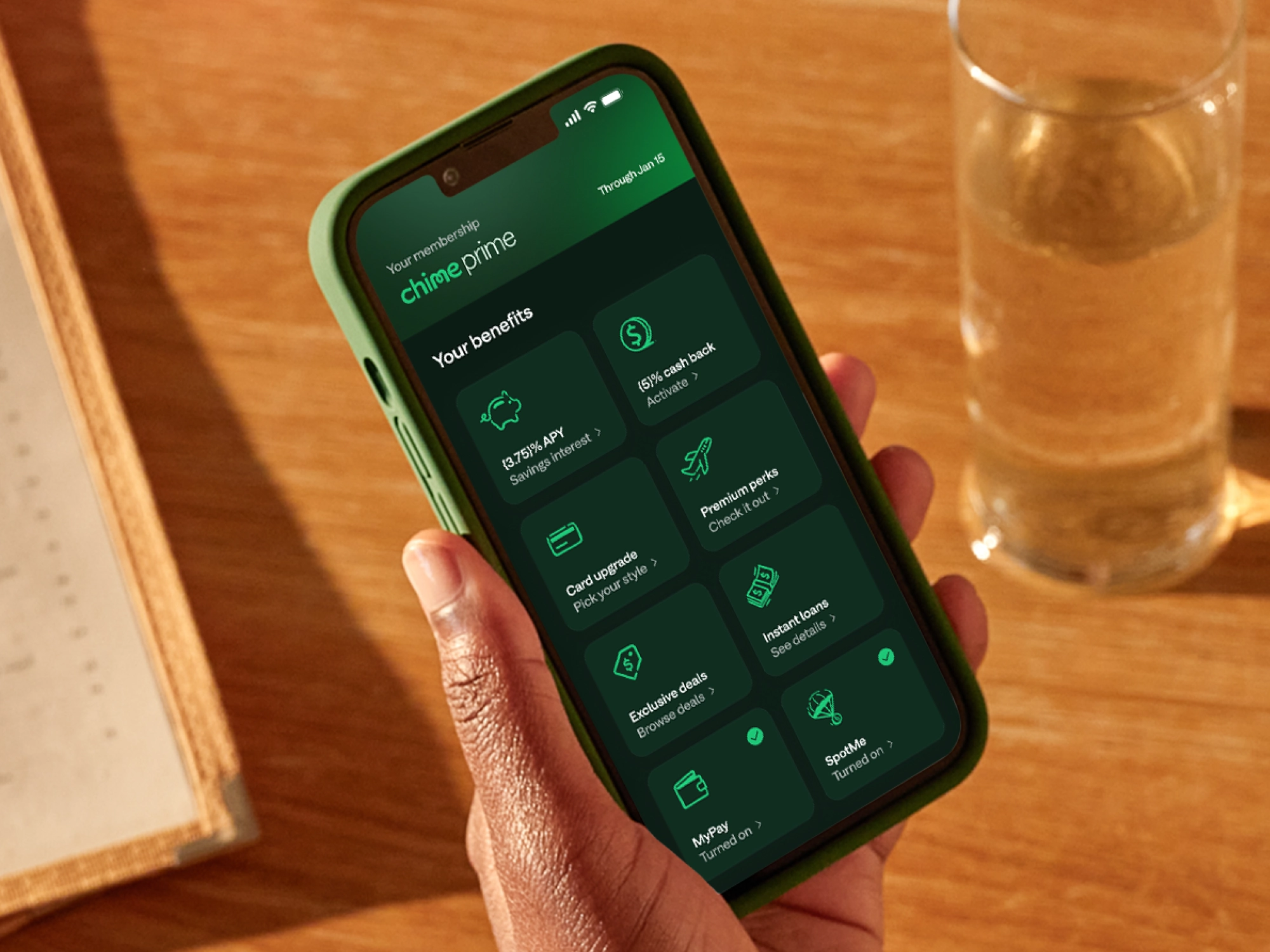 A hand holding a phone screen showing Chime Prime benefits.