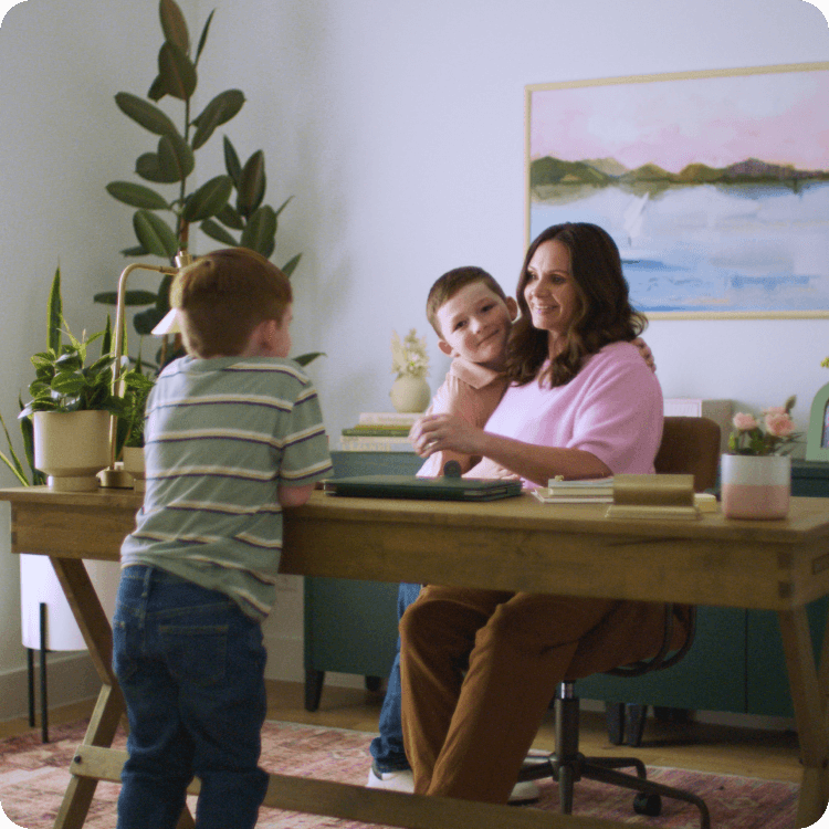 Ryan and her kids talk around her desk.