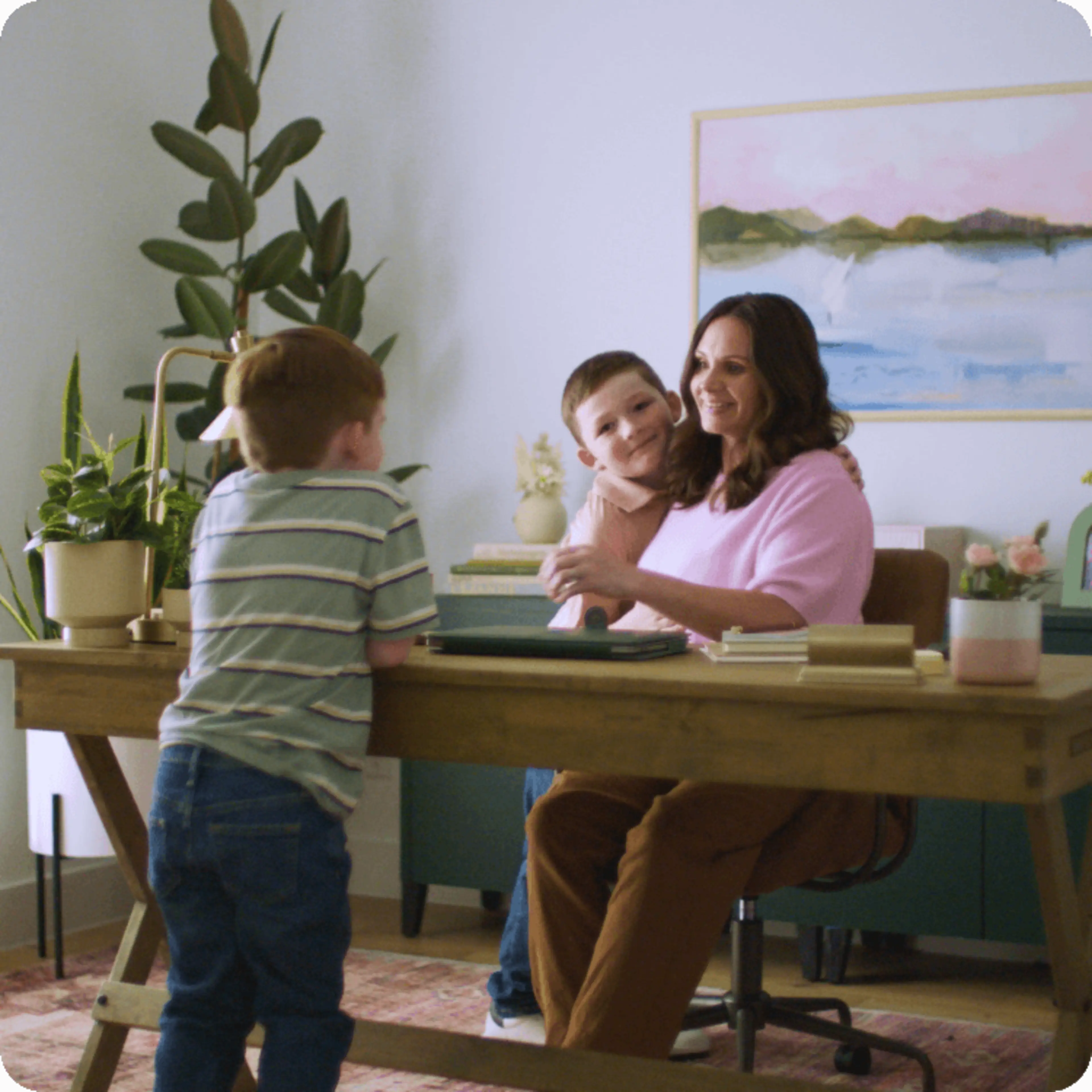 Ryan and her kids talk around her desk.