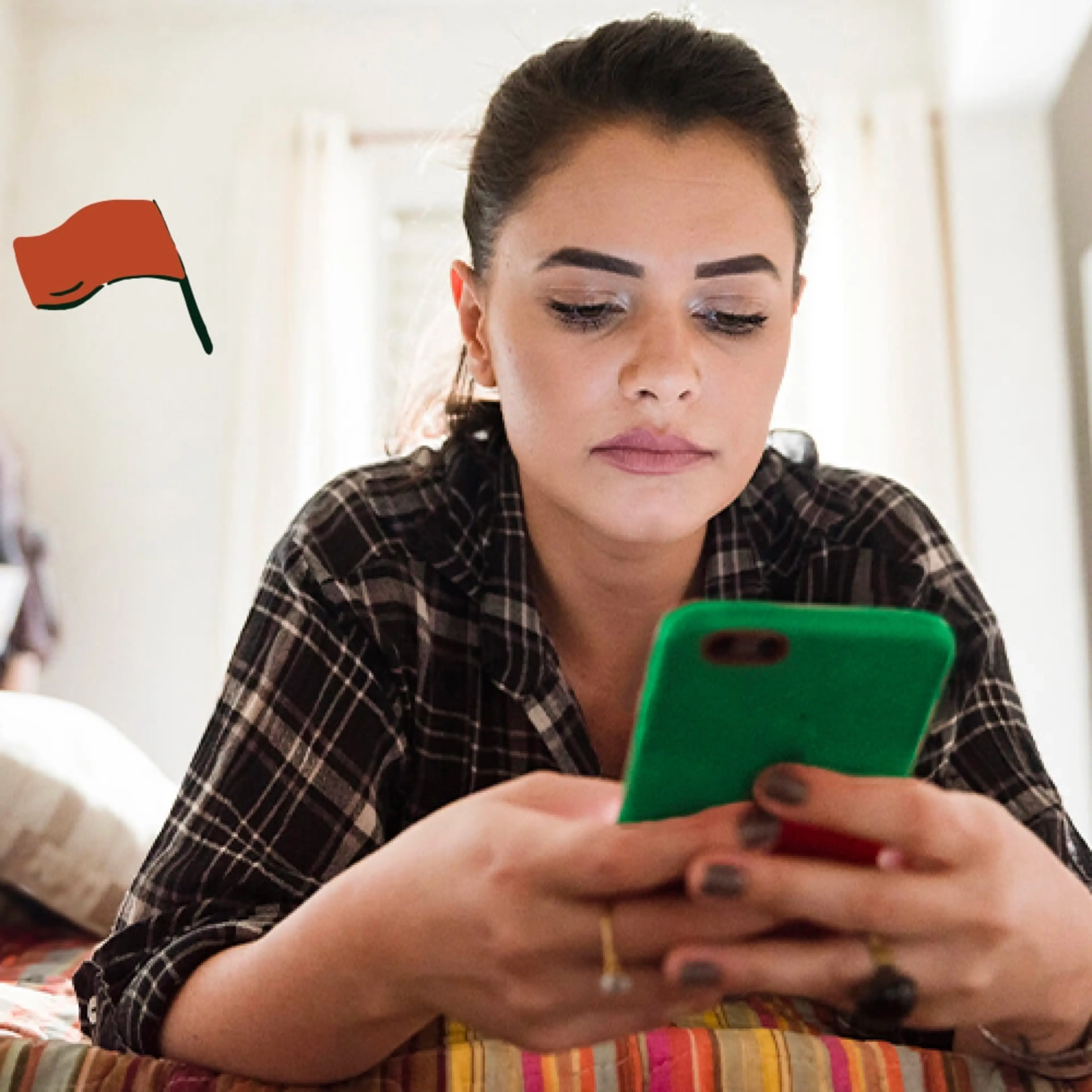 Person in plaid shirt looking at green smartphone with focused expression, small red flag icon in corner.