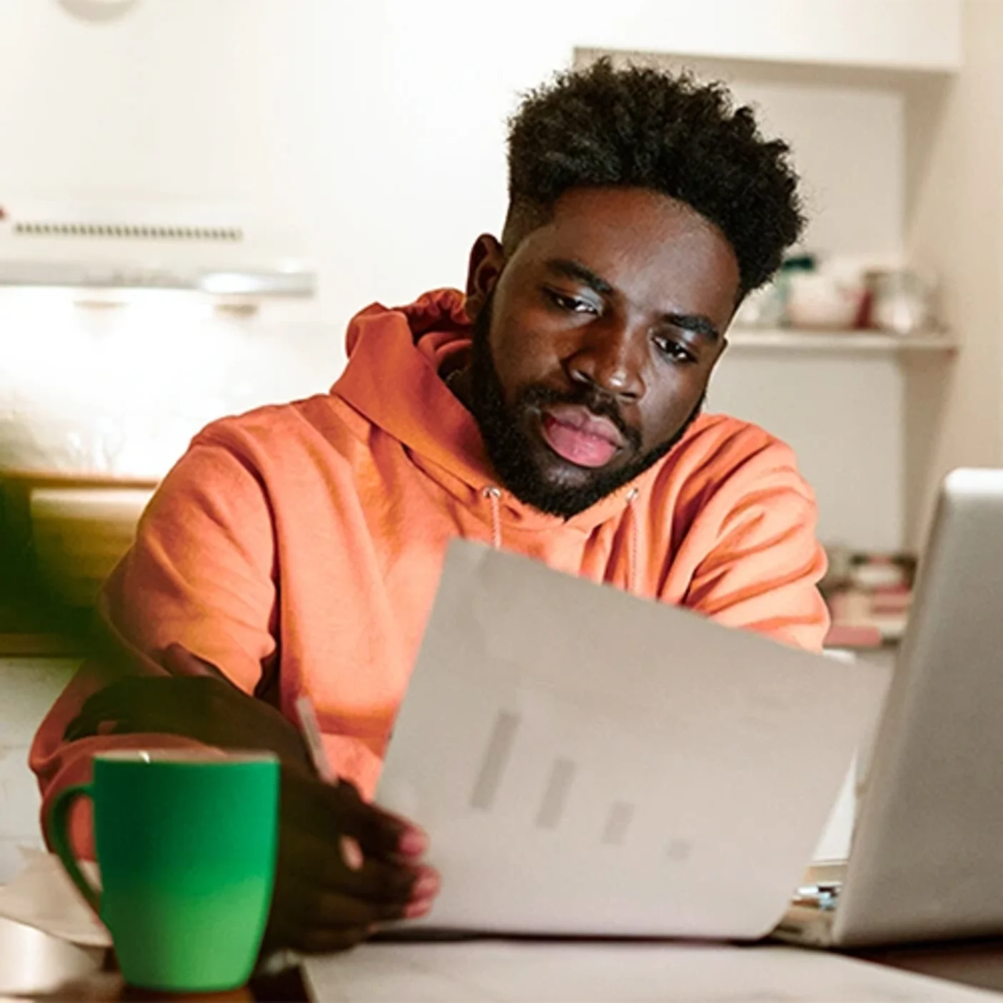 A man looks at documents and makes a payday budget routine.

