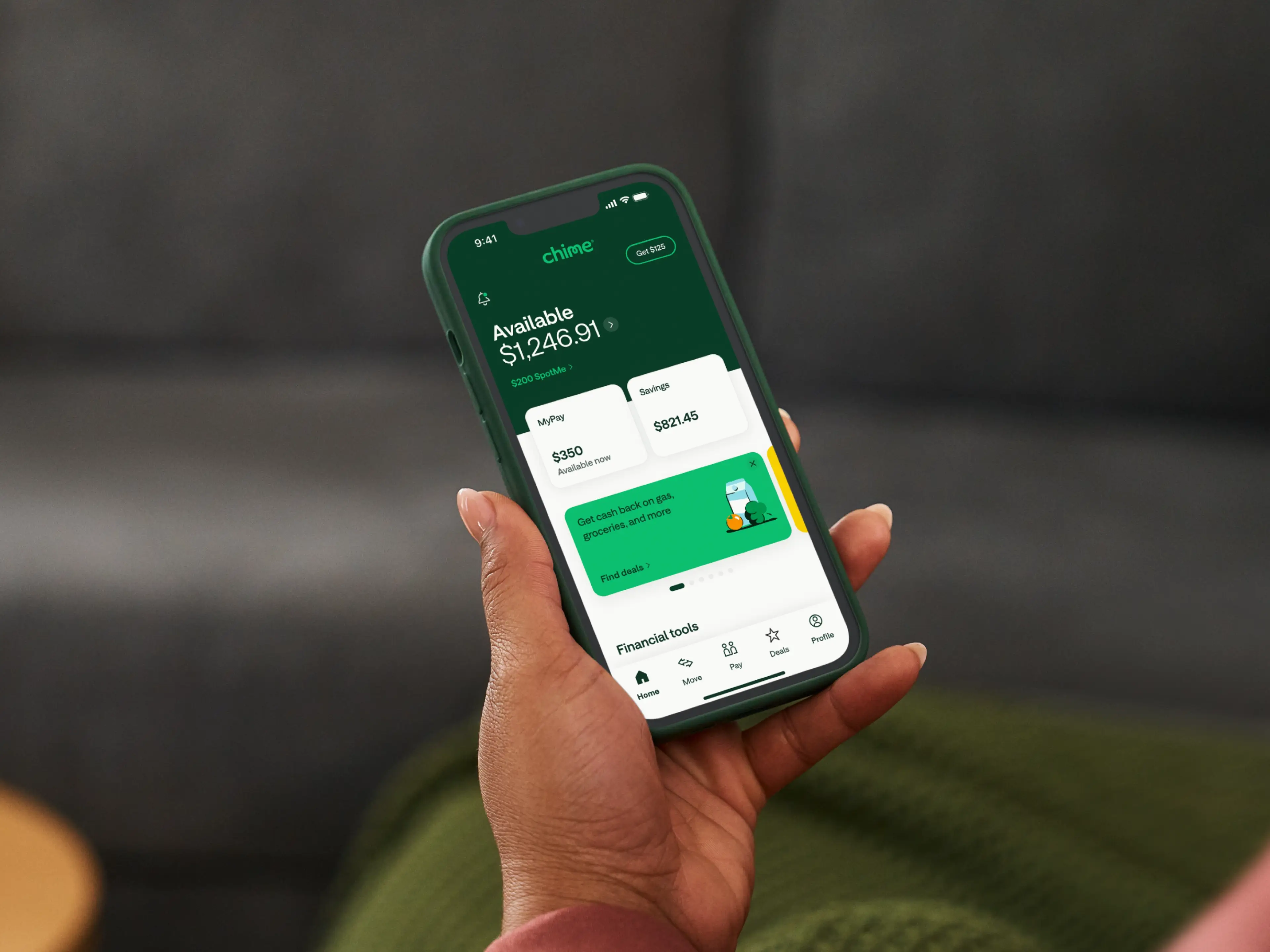 Person holding a smartphone showing Chime app with visible account balances with MyPay, savings and cash back features.