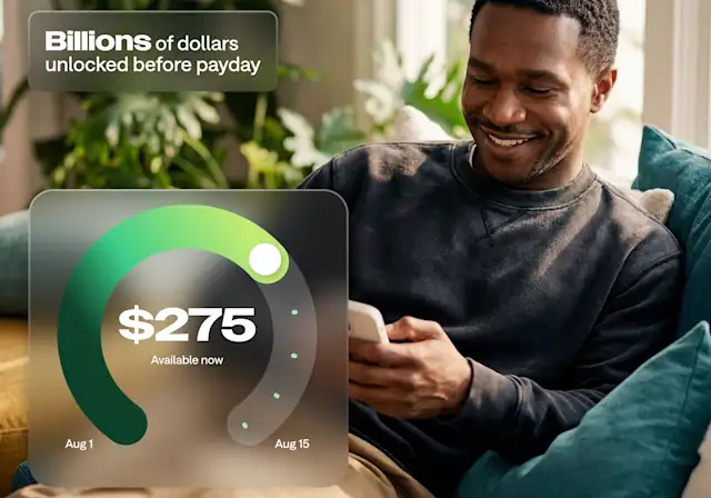 A smiling man on a couch uses his phone, with an app UI showing $275 available and text reading Billions of dollars unlocked before payday.