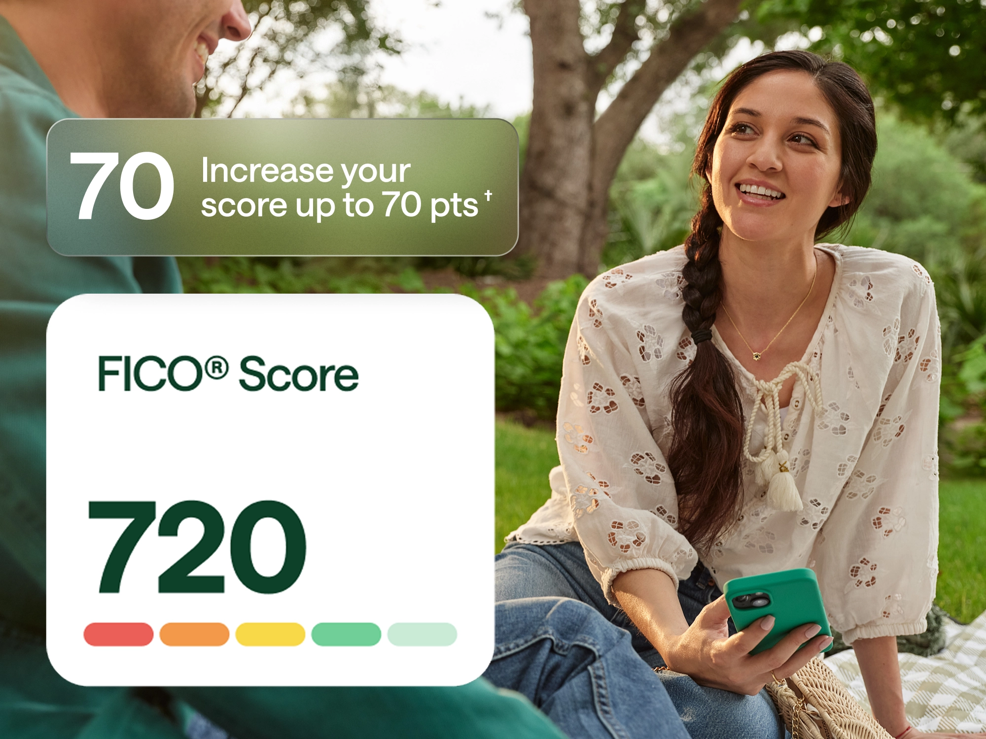 A woman sitting outdoors on a picnic blanket, smiling and holding a cellphone. A graphic overlay on the left shows a FICO® Score of 720 and a message that reads: “Increase your score up to 70 pts.” The image promotes Chime’s credit-building feature.
