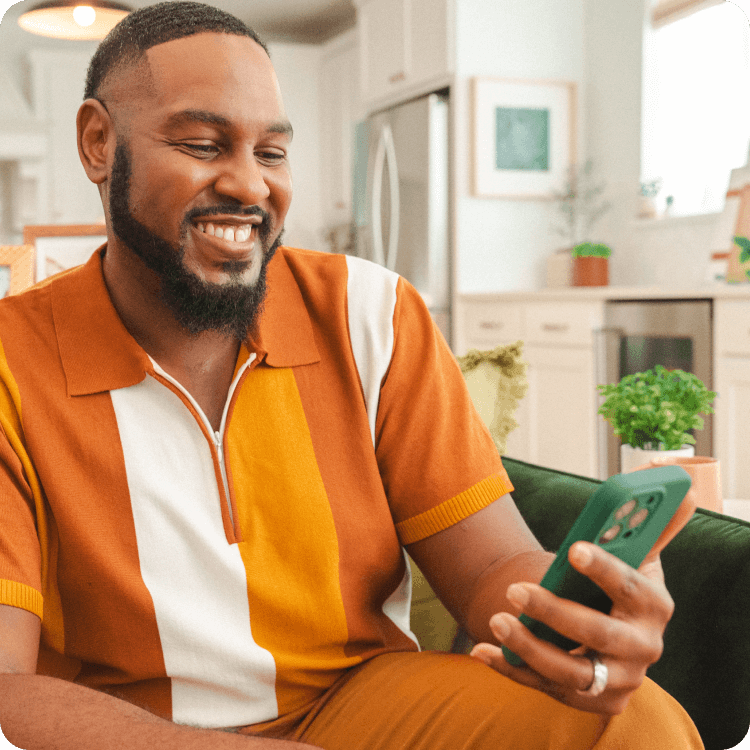 Andre uses the Chime app while sitting on the couch.
