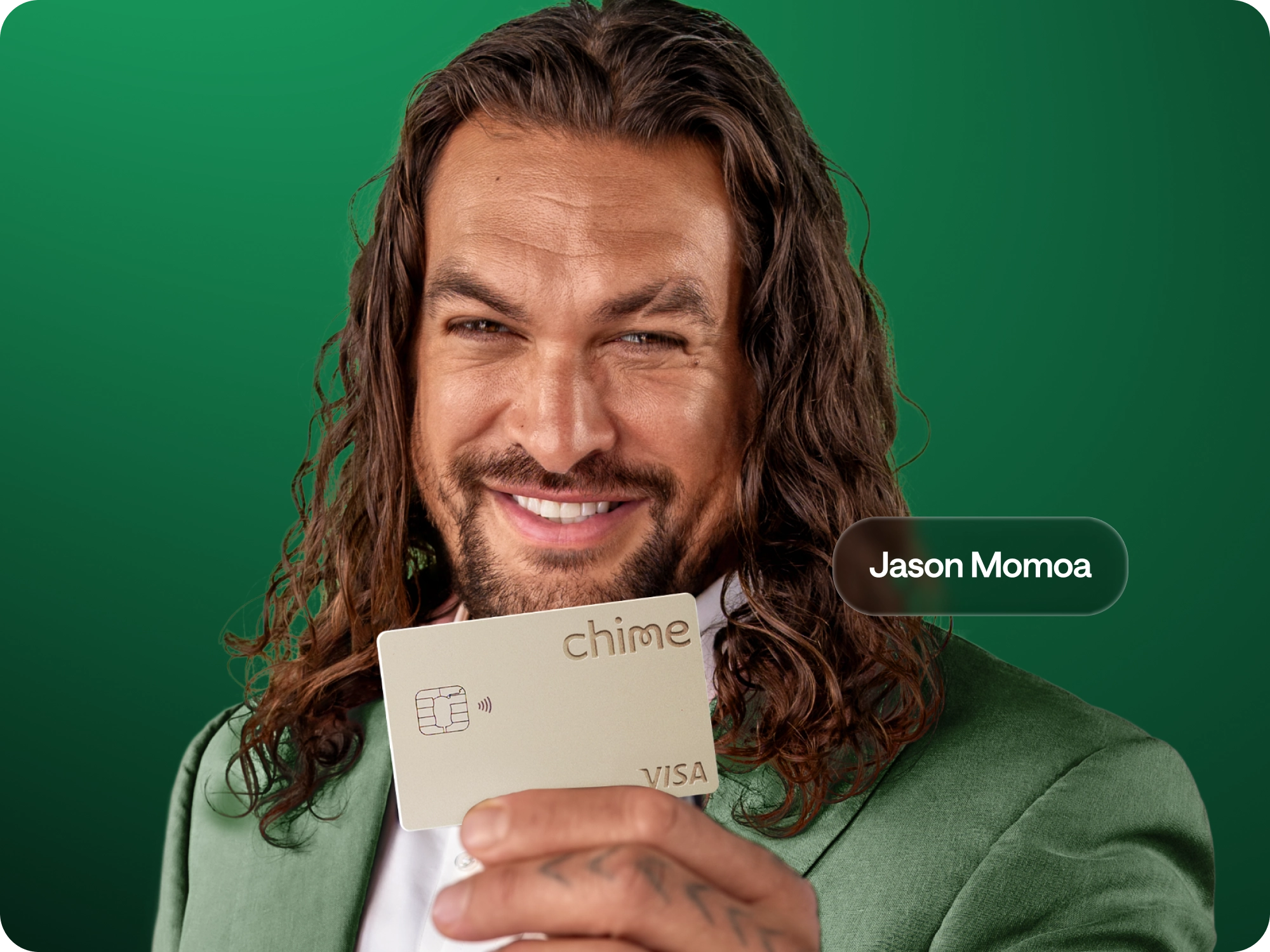 Jason Momoa holding a titanium Chime Card. Bank smarter.  