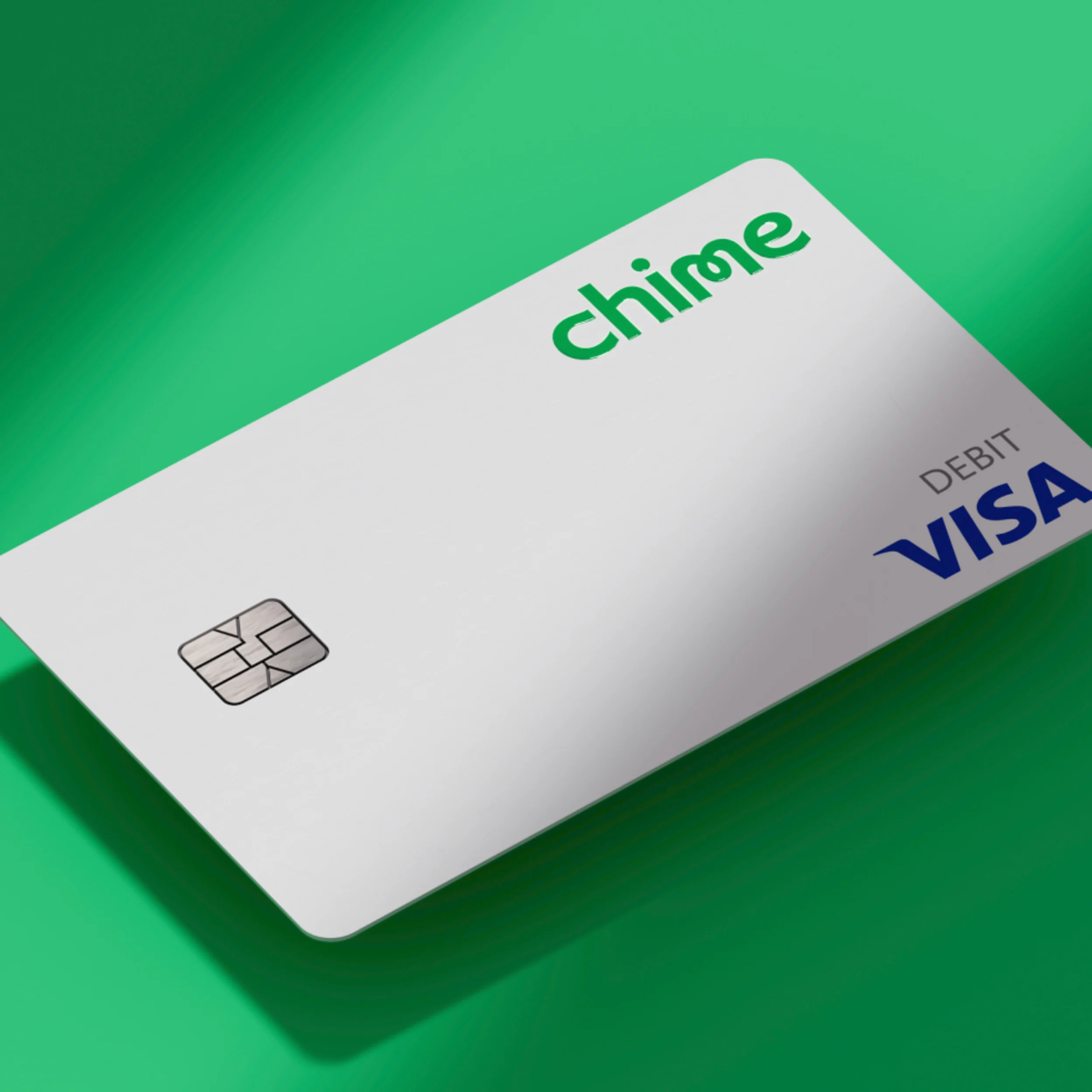 White colored Chime Visa Debit card on green background. 