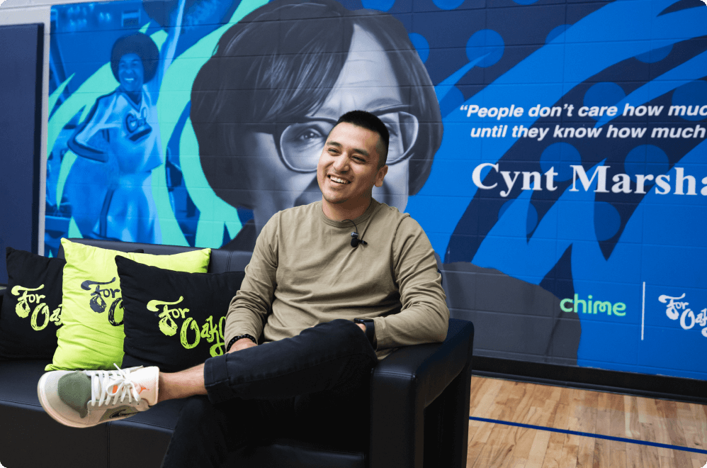 A Chime Community Changemaker sitting in a chair. 