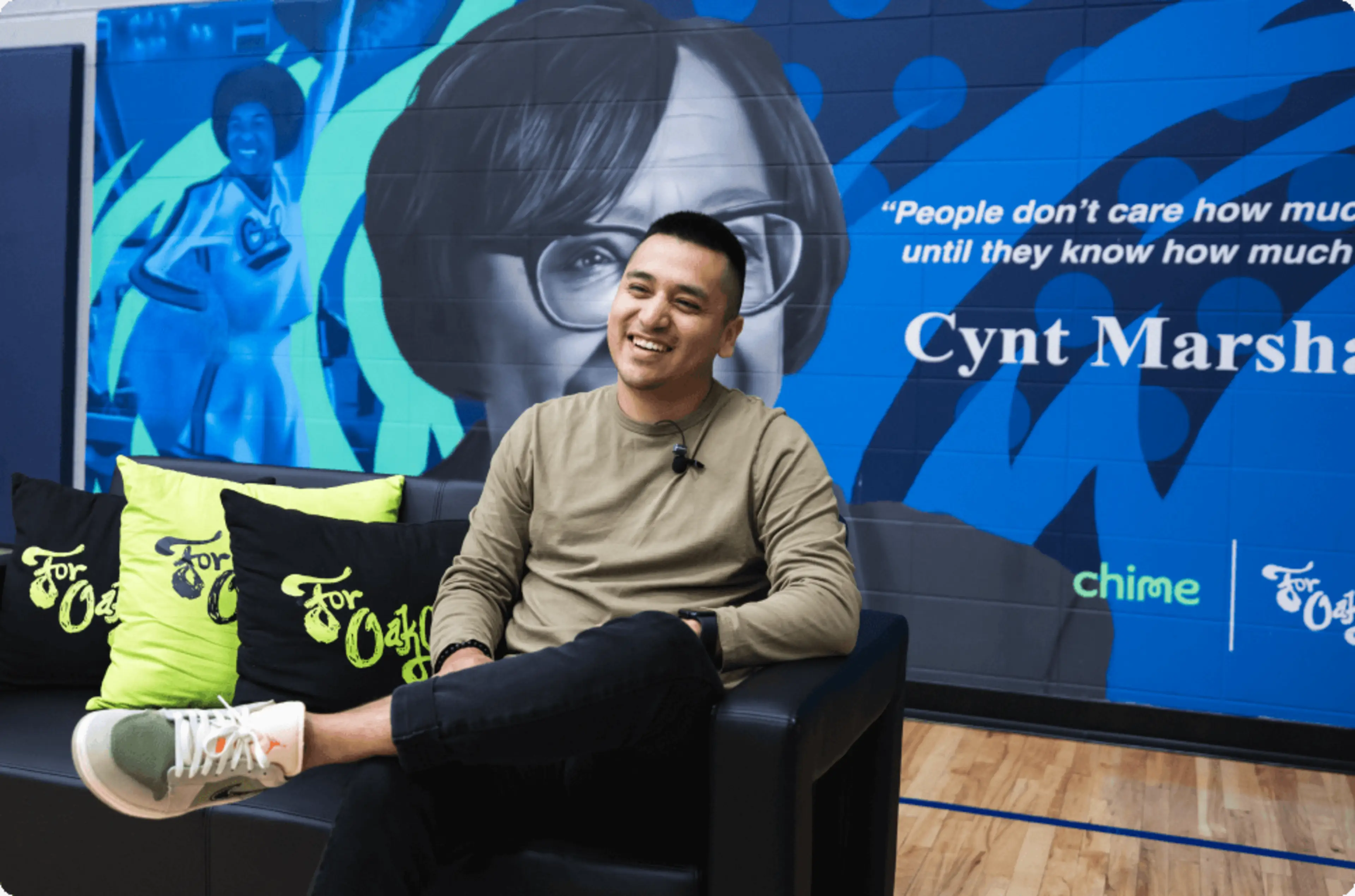 A Chime Community Changemaker sitting in a chair.