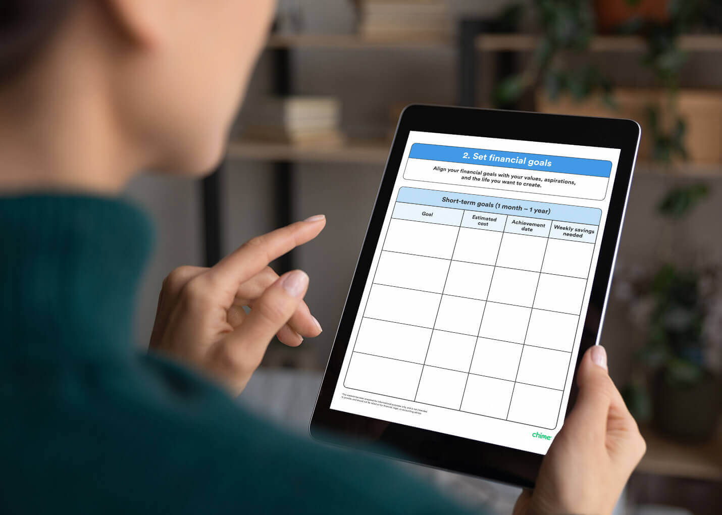 A closeup shows a woman holding an iPad that displays a downloadable financial goals planner. 