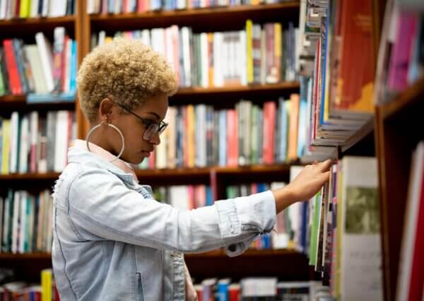 A woman browses the shelves of a bookstore.