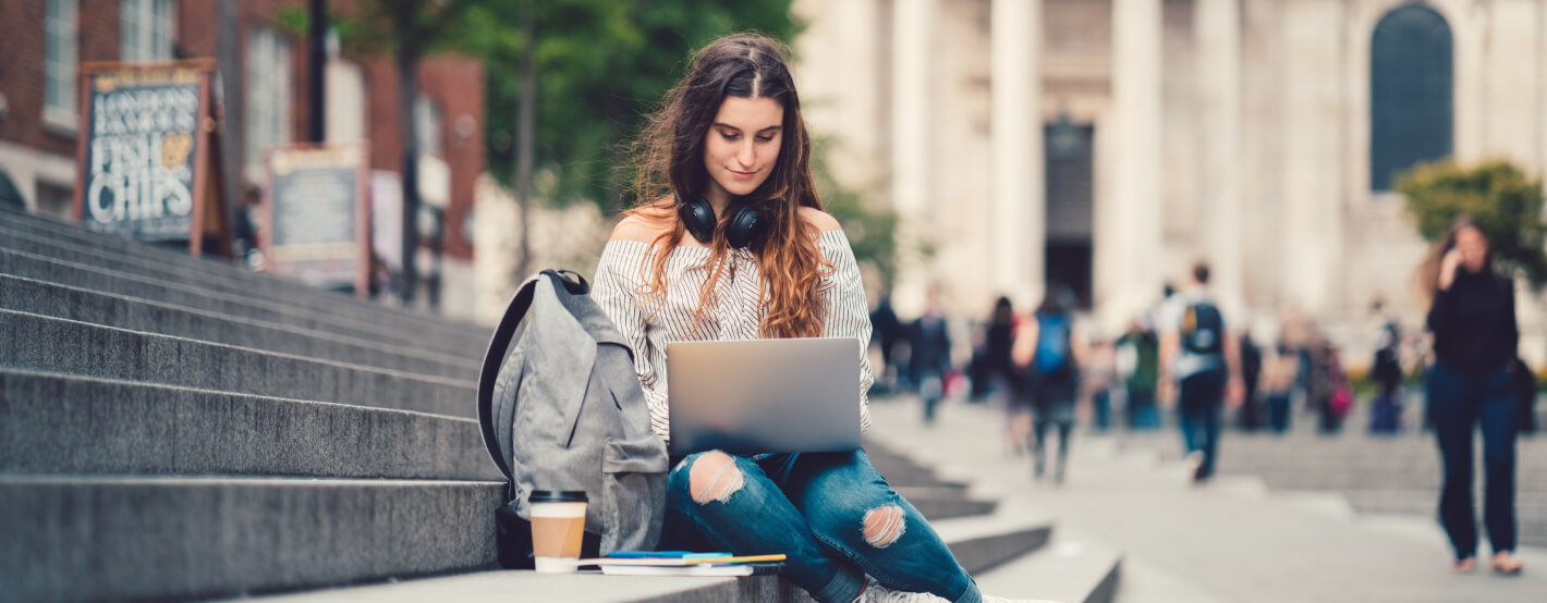 College student using laptop to review expenses