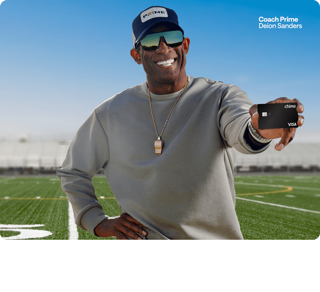 Deion Sanders holding Chime Card